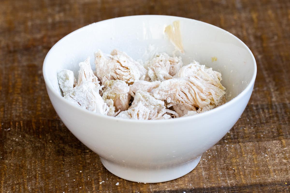jackfruit tossed with cornstarch in a small white bowl