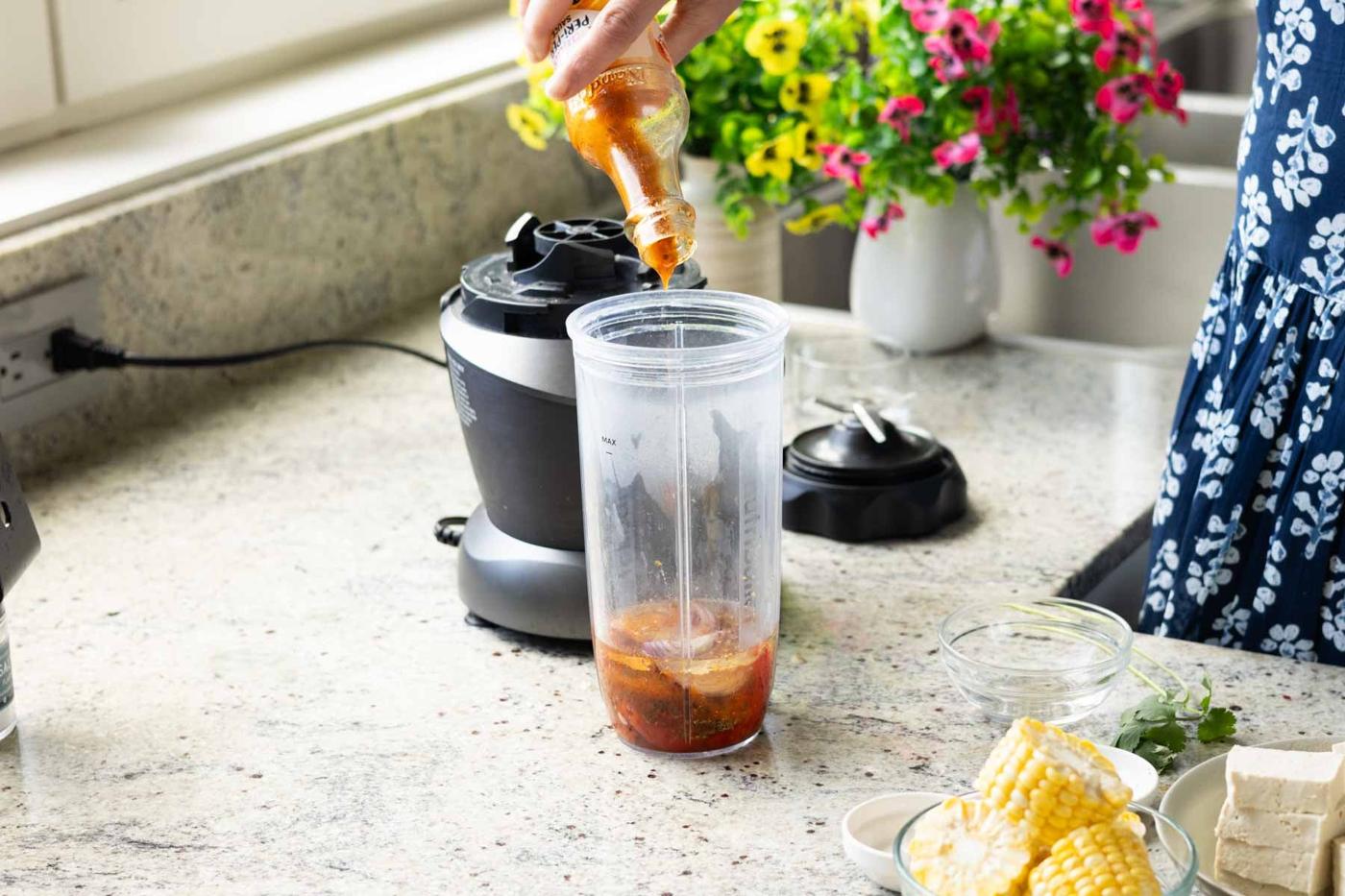 adding peri-peri sauce to the blender
