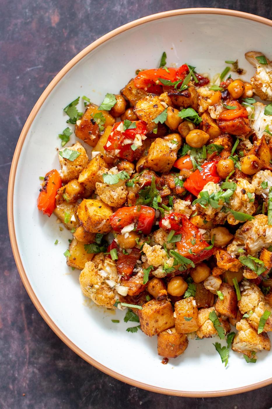 vegan roasted root veggies with cauliflower and chickpeas served sprinkled with cilantro