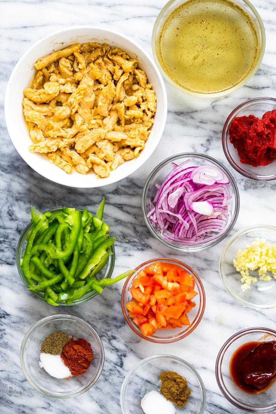 ingredients for vegan skillet enchiladas on a marble countertop