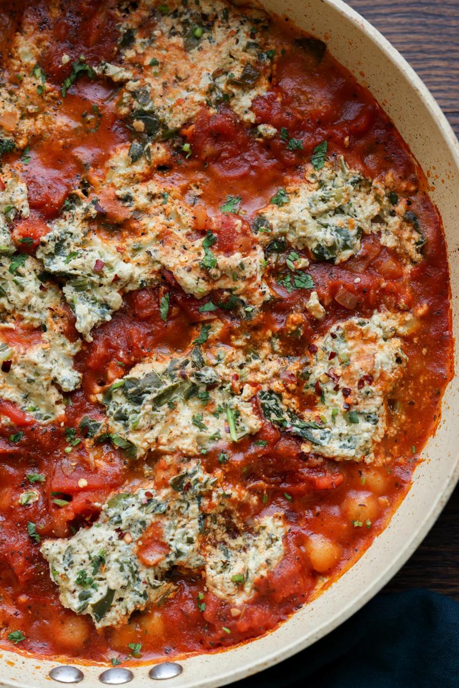 close-up of skillet gnocchi in the pan with tofu ricotta and sun dried tomato sauce