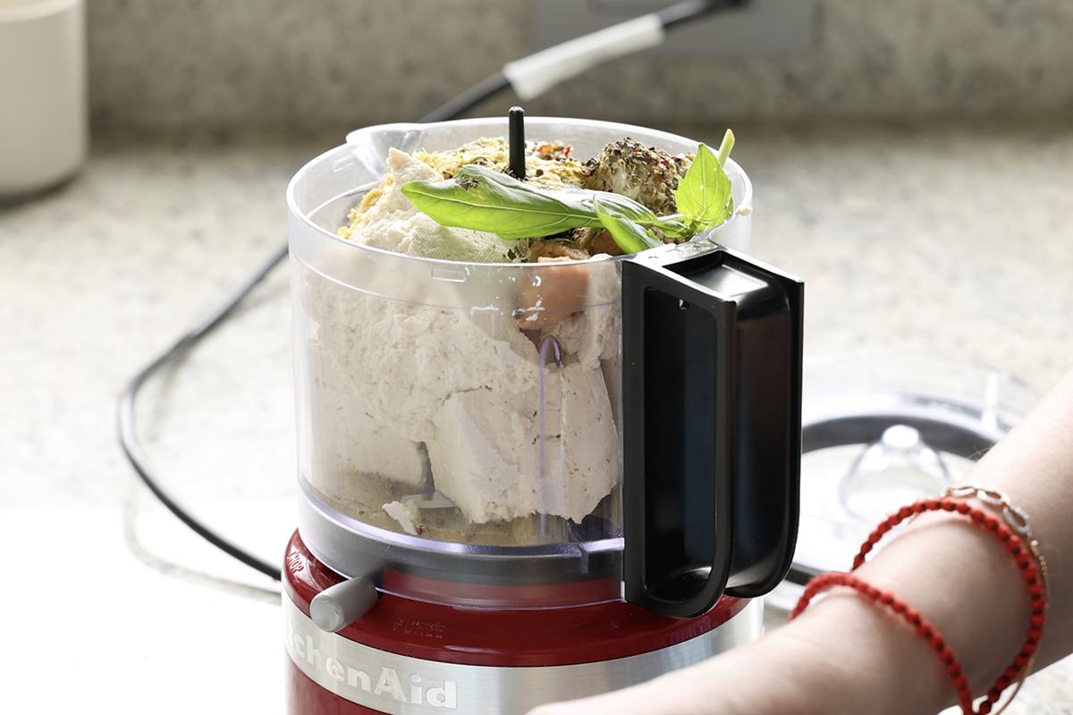 adding tofu ricotta ingredients to the food processor
