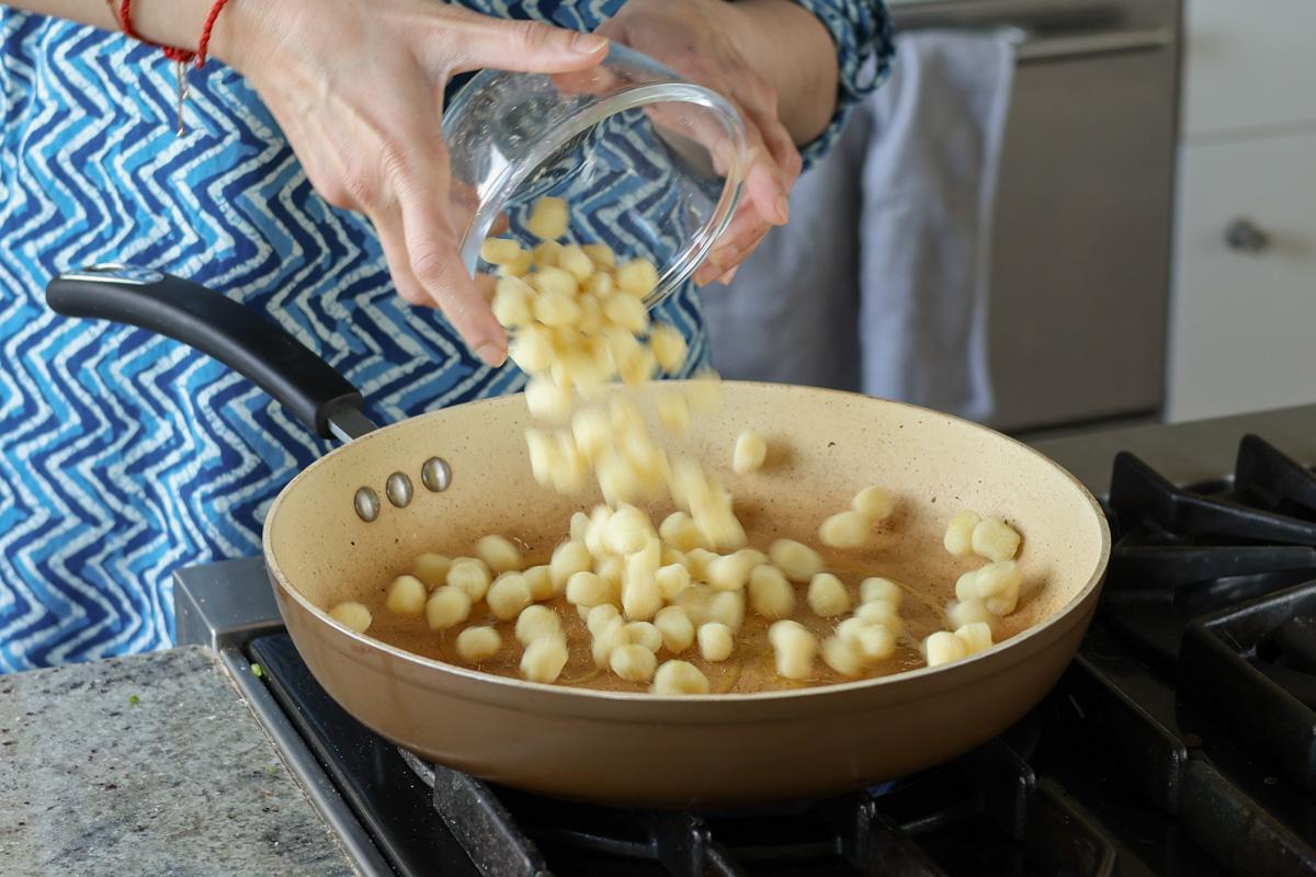 adding the gnocchi to the skillet