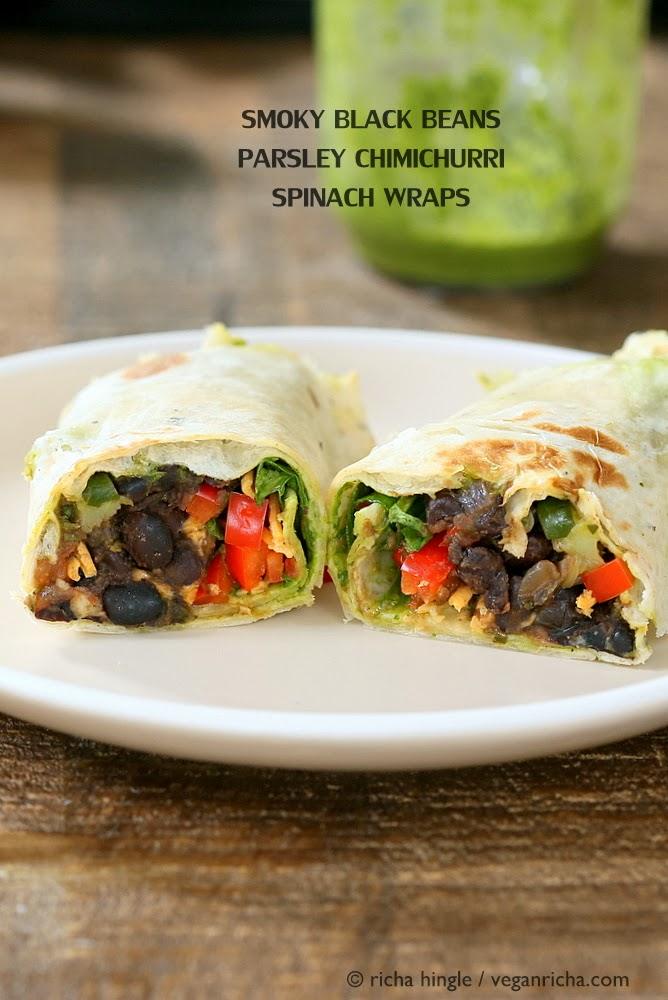 side view of two halves of a vegan wrap with black beans, bell pepper and vegan cheese on a white plate