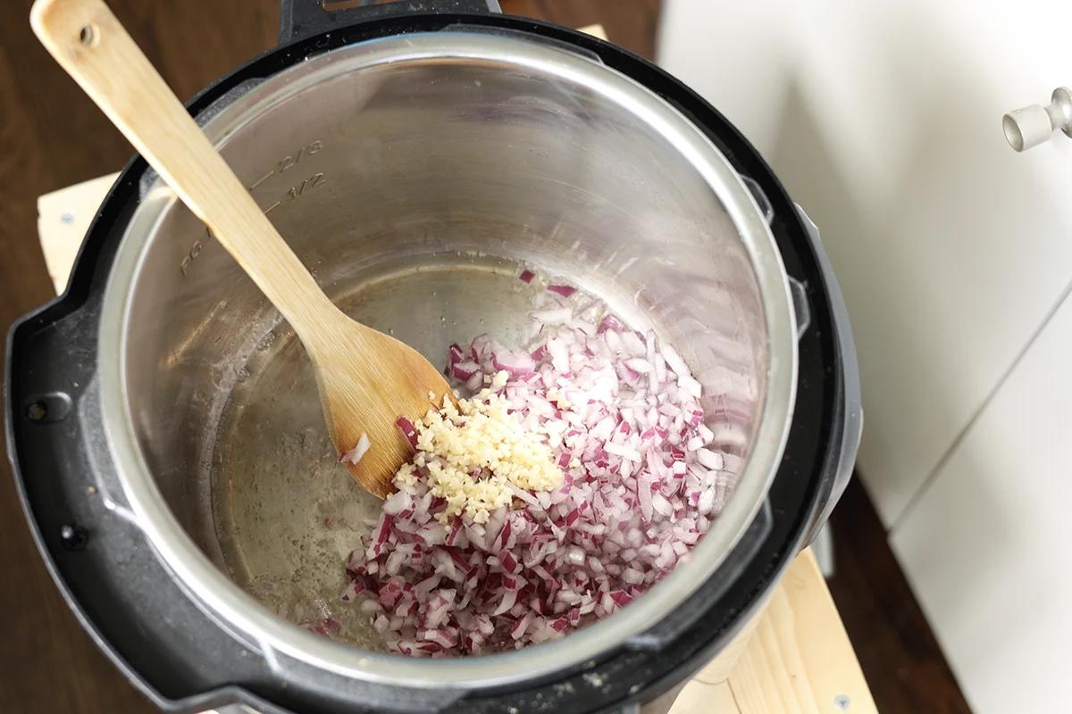 adding onion and garlic to the Instant Pot