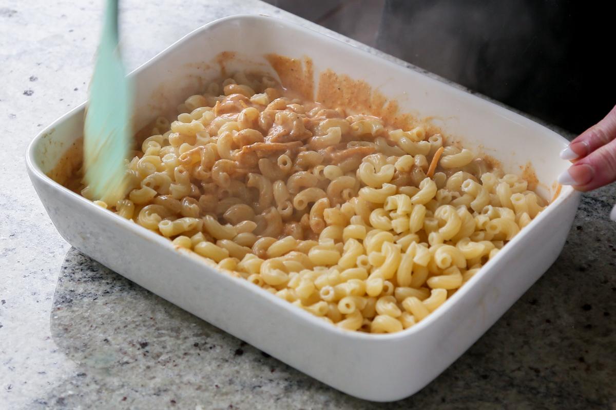 mixing the pasta into the sauce