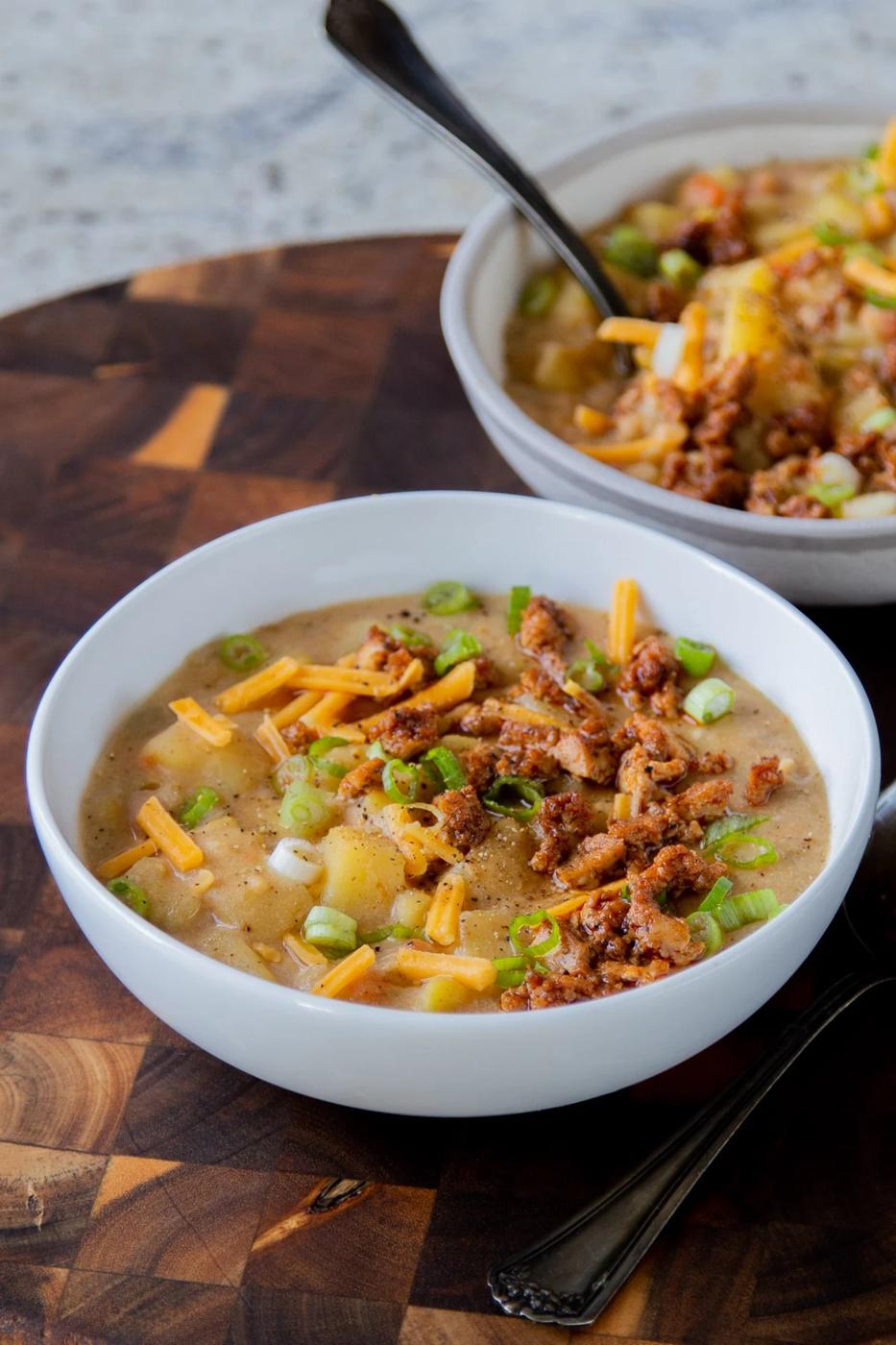 bowls of vegan potato soup topped with smoky crumbled tofu