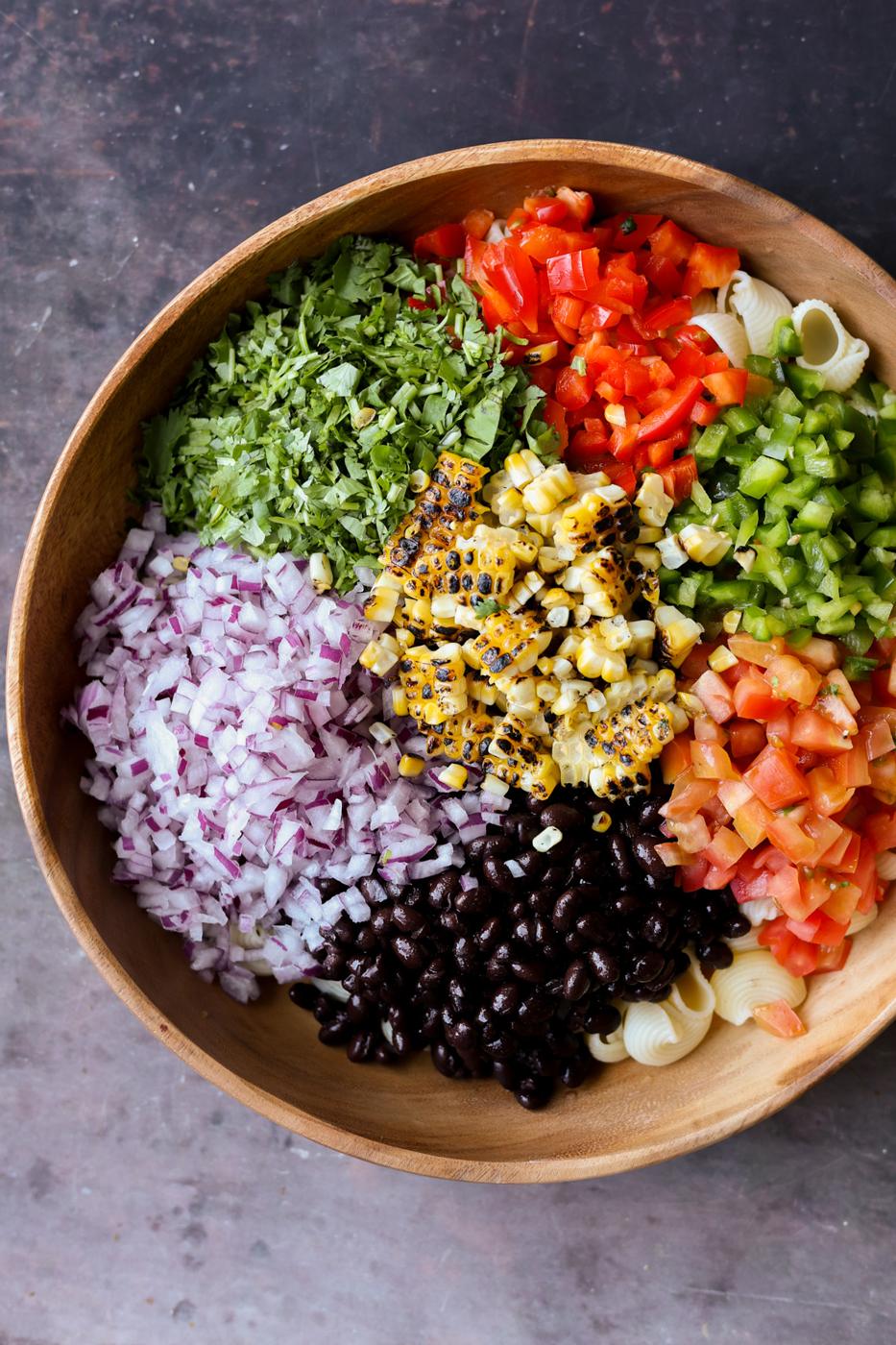 Large wooden bowl with ingredients for southwestern salad.