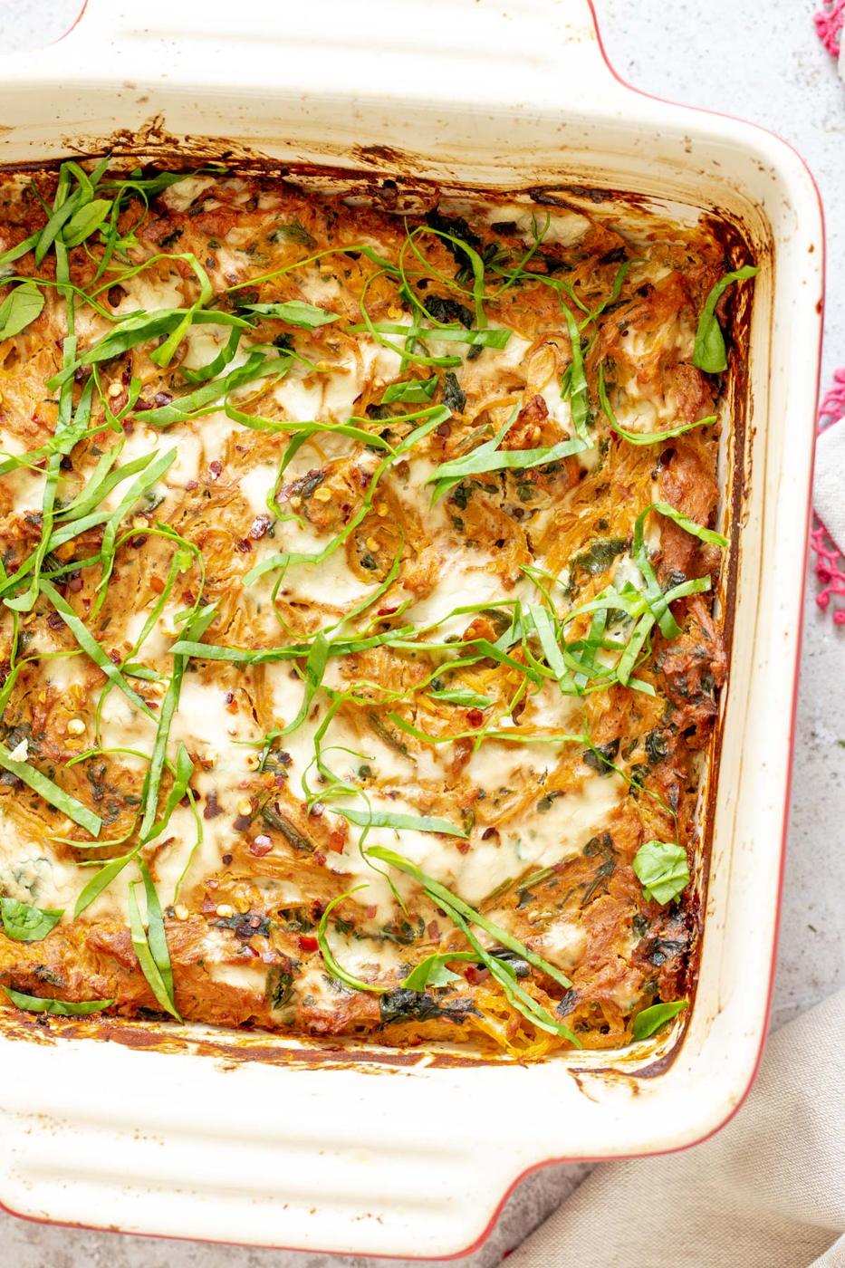vegan Italian Sun-dried tomato Spaghetti Squash Pasta Bake in a white casserole dish
