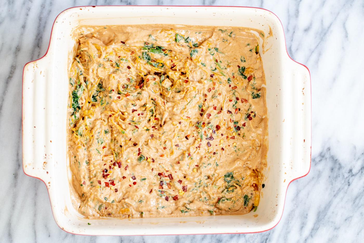 vegan creamy sun-dried tomato spaghetti squash bake ready to be baked