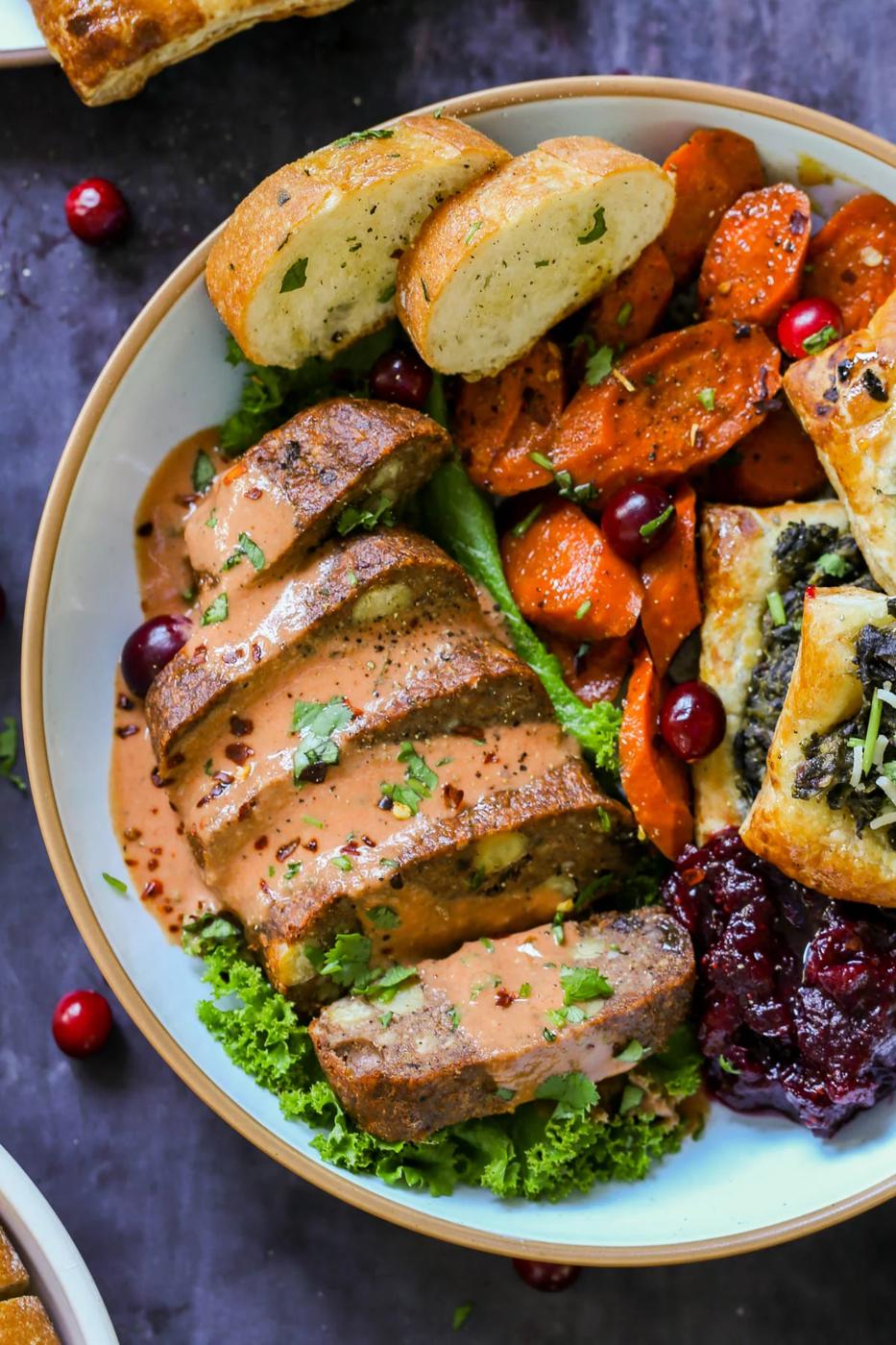chickpea loaf on a plate as part of a vegan Indian Thanksgiving spread