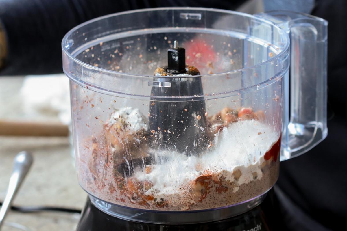 adding flour and spices to the food processor