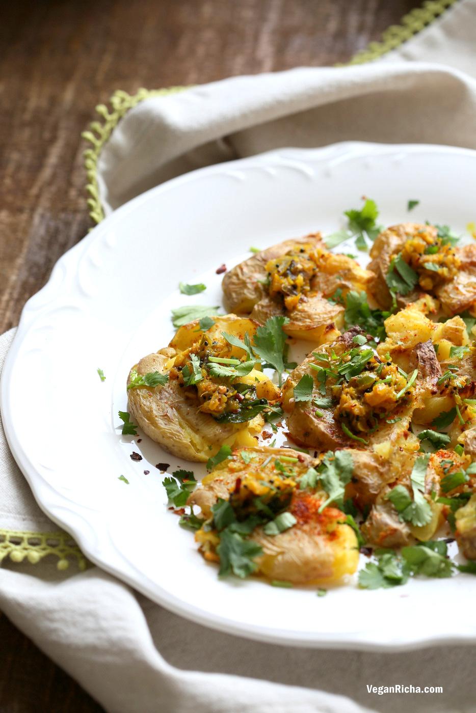 Indian Spiced Smashed Potatoes with Mustard Ginger Tempering. Bonda like Samosa is a spiced potato snack. These smashed potatoes are topped with Bonda style tempering of ginger, chile, turmeric and mustard seeds. Vegan Gluten-free Recipe | VeganRicha.com