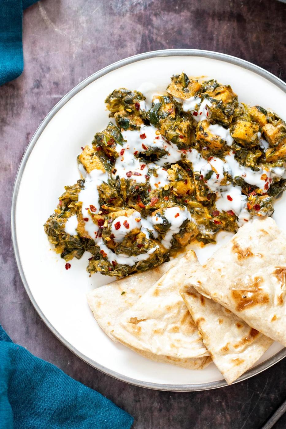 spicy Indian tofu spinach stirfry served with a side of flatbread
