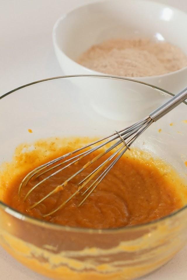 wet ingredients for vegan sweet potato donuts being whisked in a glass bowl