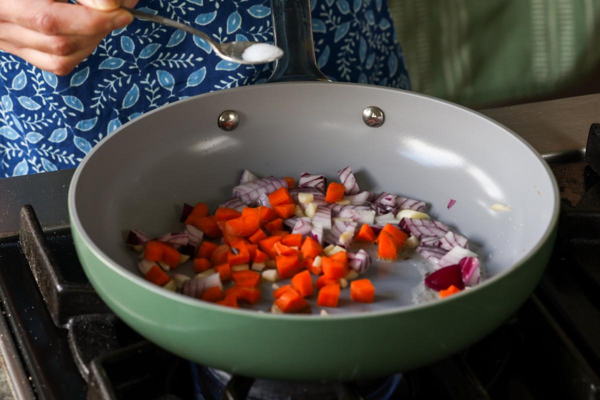 adding veggies to the pan