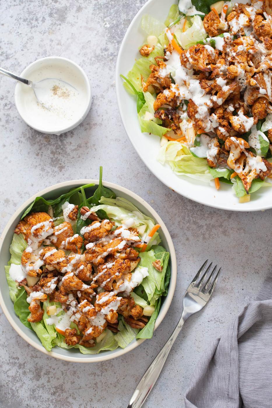 vegan roasted cauliflower salad bowl drizzled with Vegan Ranch Dressing