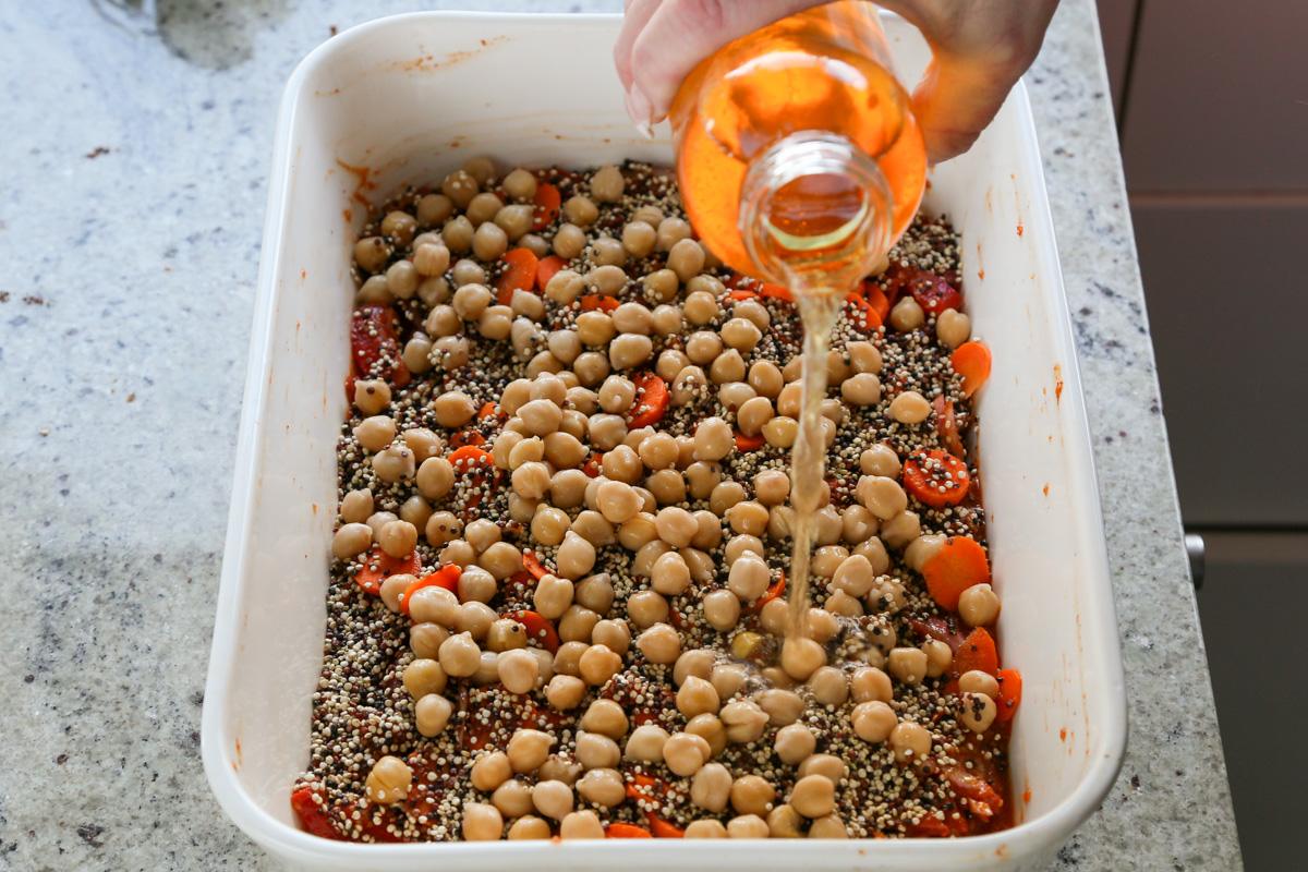 adding chickpeas and broth to the pan