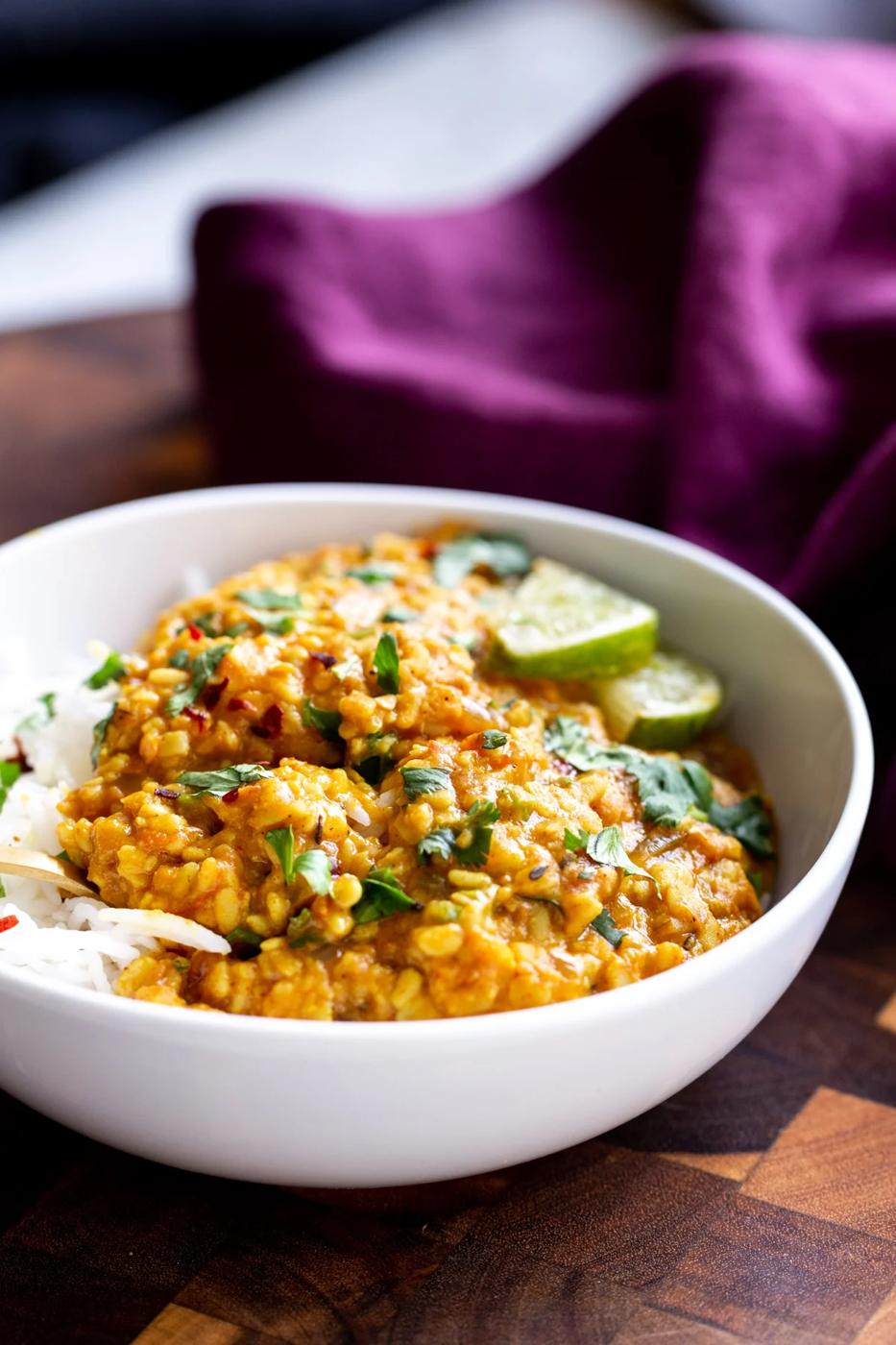 spicy urad dal served in a white bowl