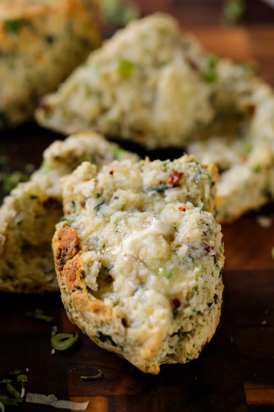 close-up of a vegan savory scone spread with butter