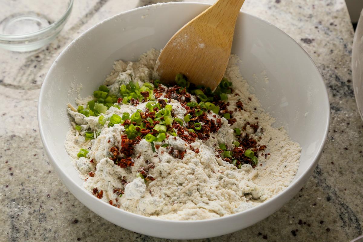 adding green onion and sun-dried tomato to the dry ingredients