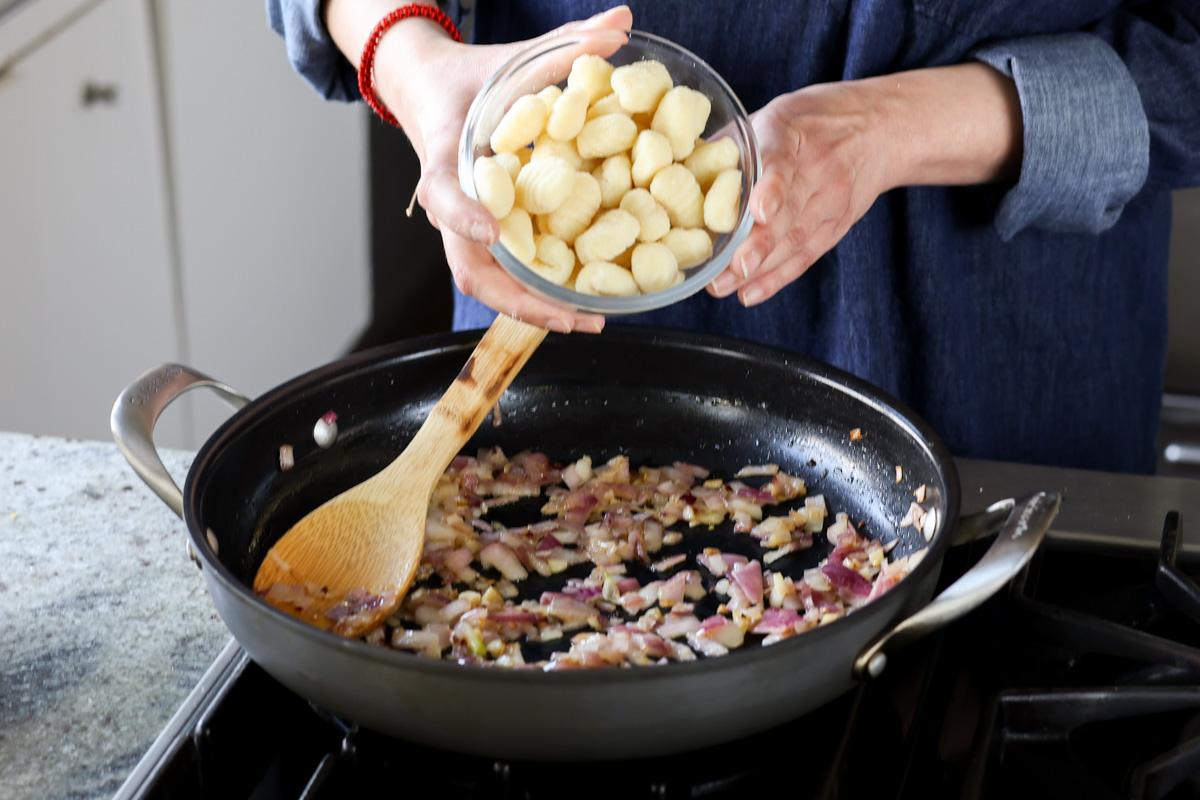 adding gnocchi to the pan
