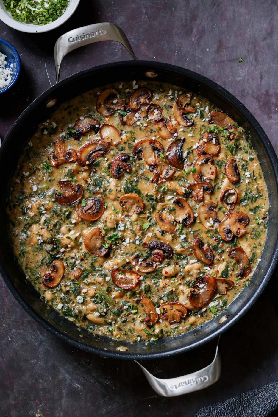 spinach mushroom beans in the pan with garnish