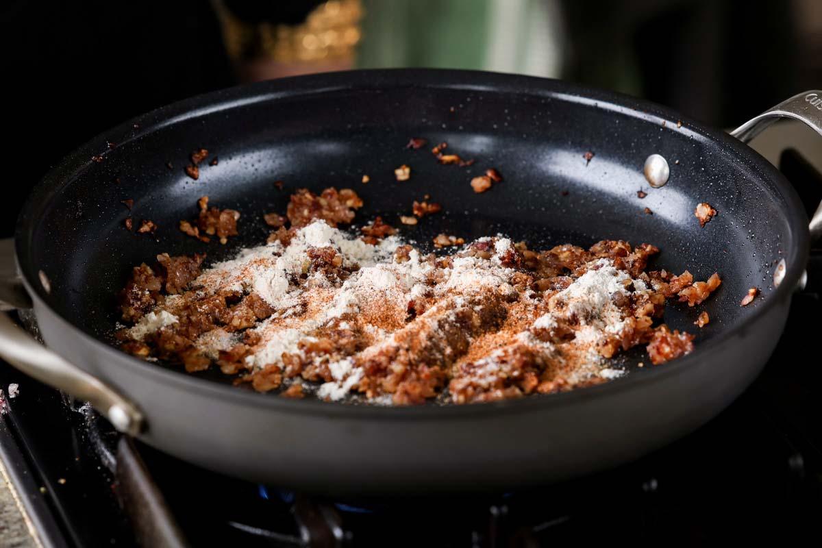 adding flour to the pan