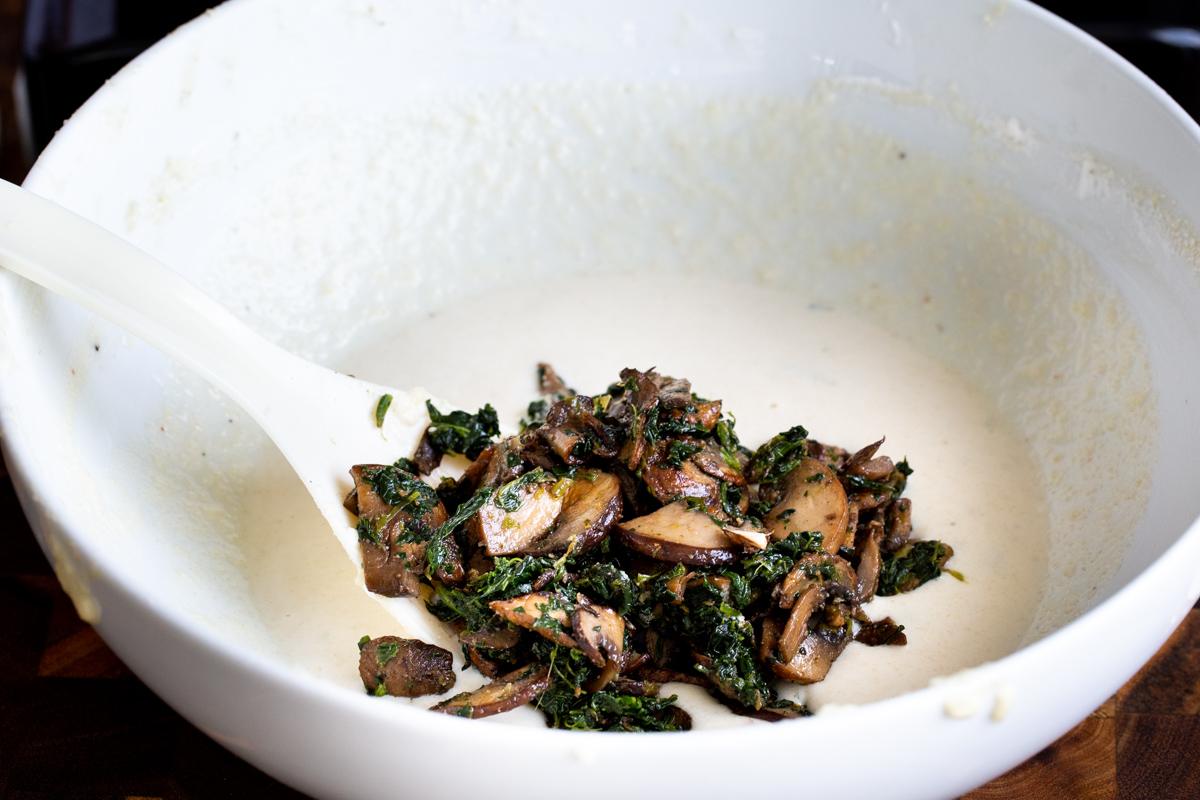 spinach mushroom mix being added to vegan naan batter