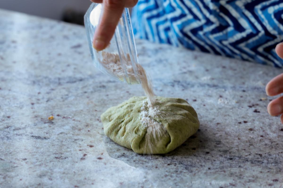 adding flour to the dough