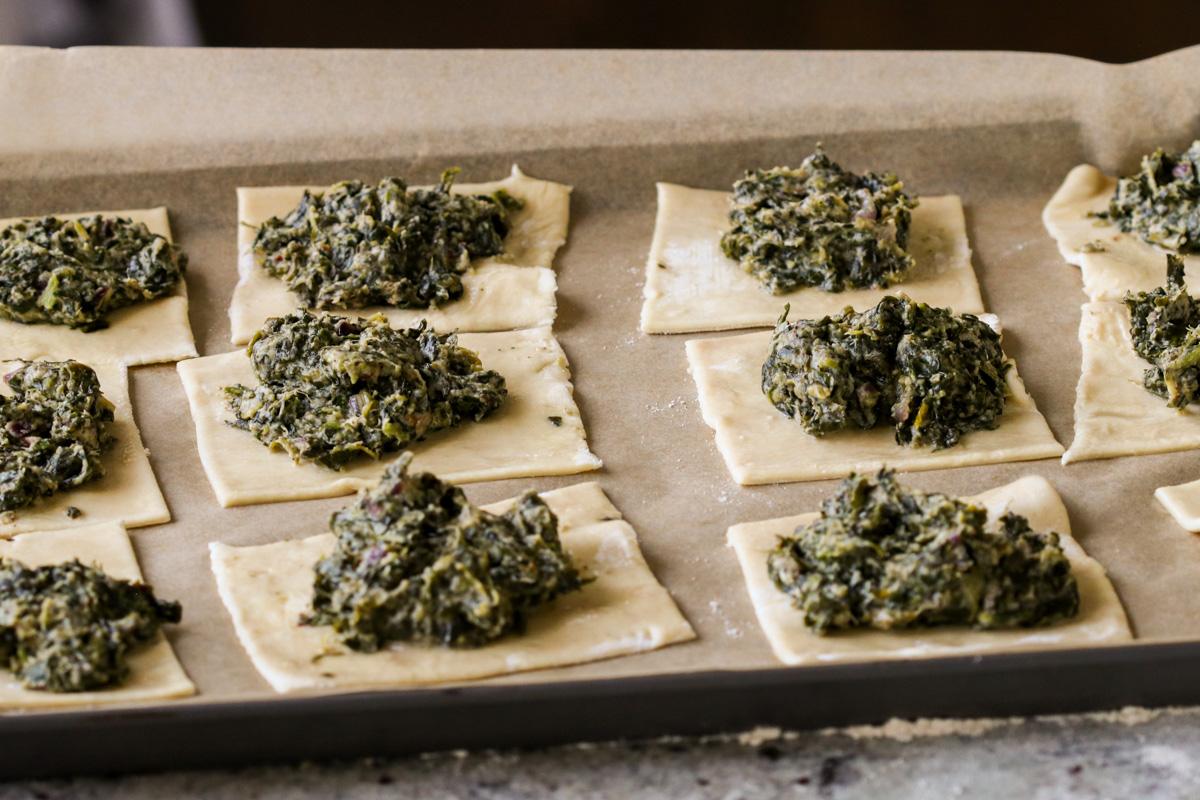 puff pastry after adding spinach mixture to the center on the baking sheet, before baking
