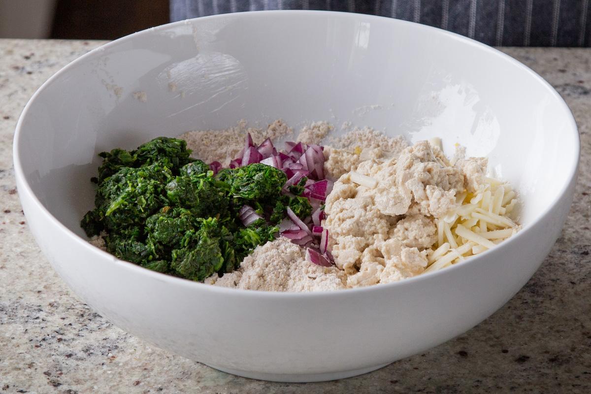 adding spinach, onion, and cilantro to the dry ingredients
