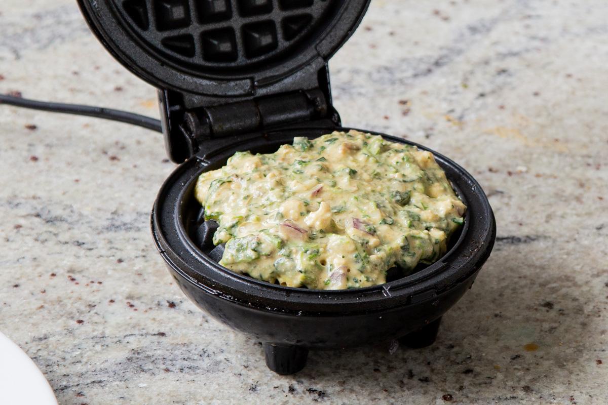 palak tofu waffle batter in the waffle iron
