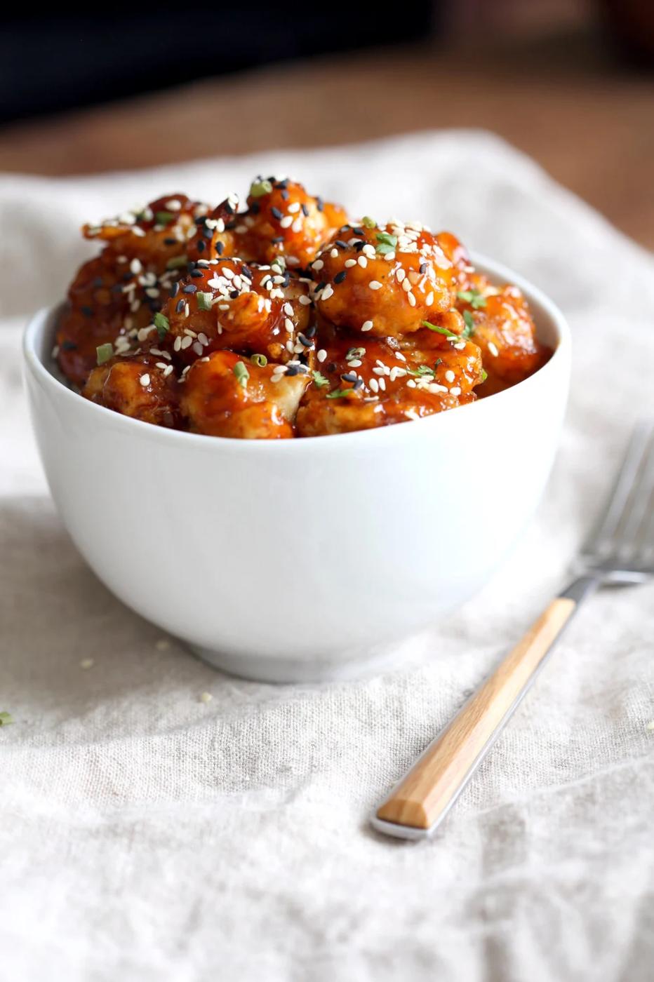 Vegan Sticky Sesame Cauliflower over rice in a white bowl