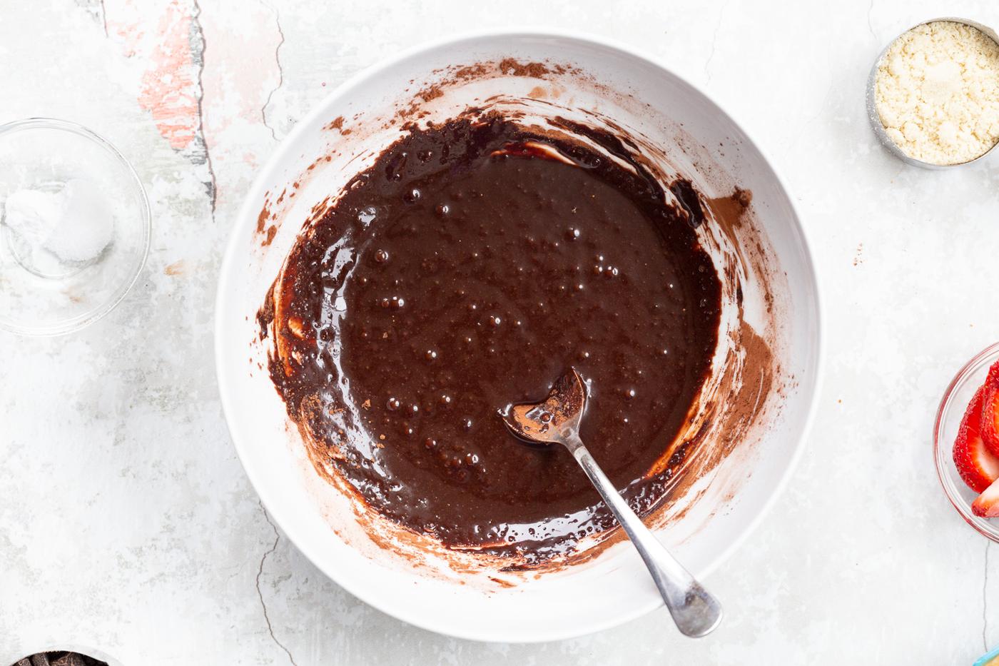 Wet chocolate mixture for our Vegan Strawberry Brownies in a white bowl
