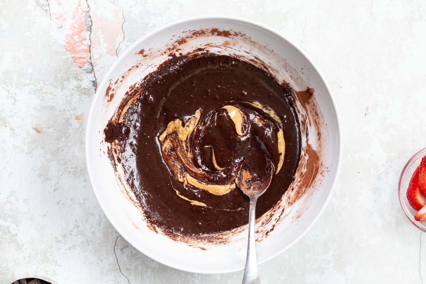 Wet chocolate mixture for our Vegan Strawberry Brownies in a white bowl