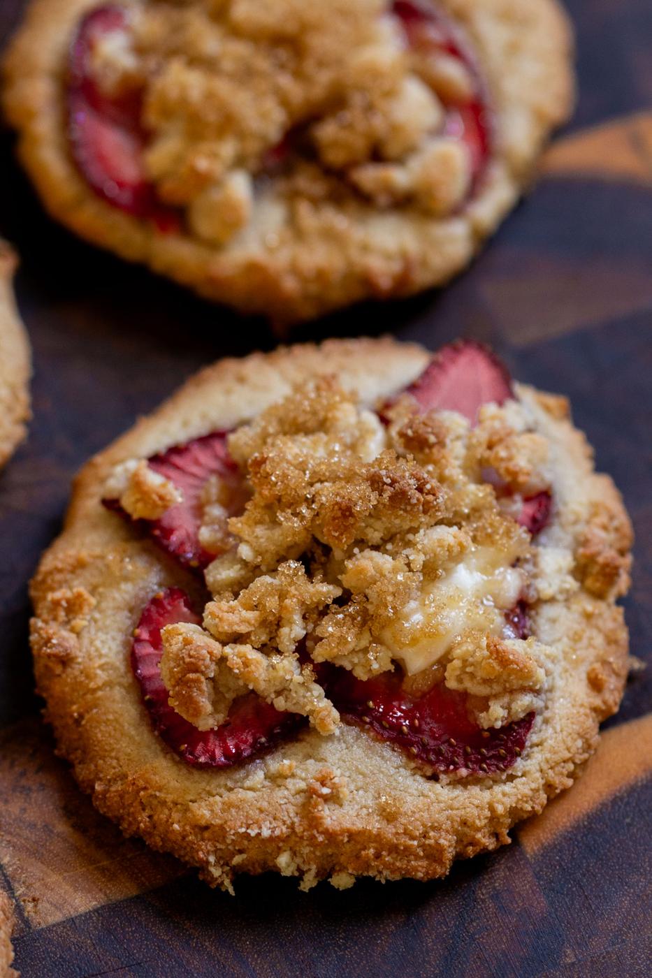 close-up of strawberry cheesecake cookies on a wooden serving tray