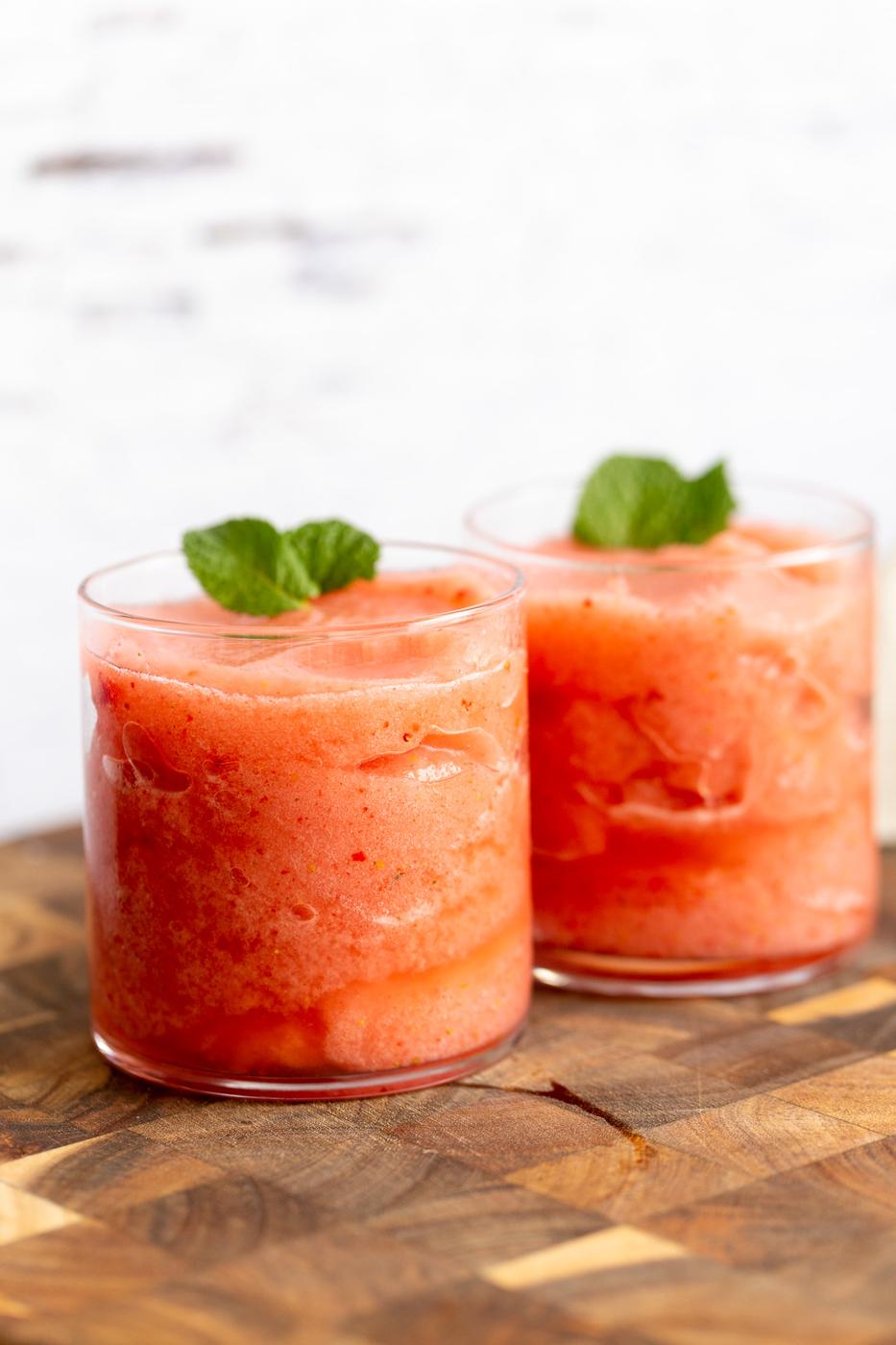 two glasses with homemade vegan strawberry lemonade slushies