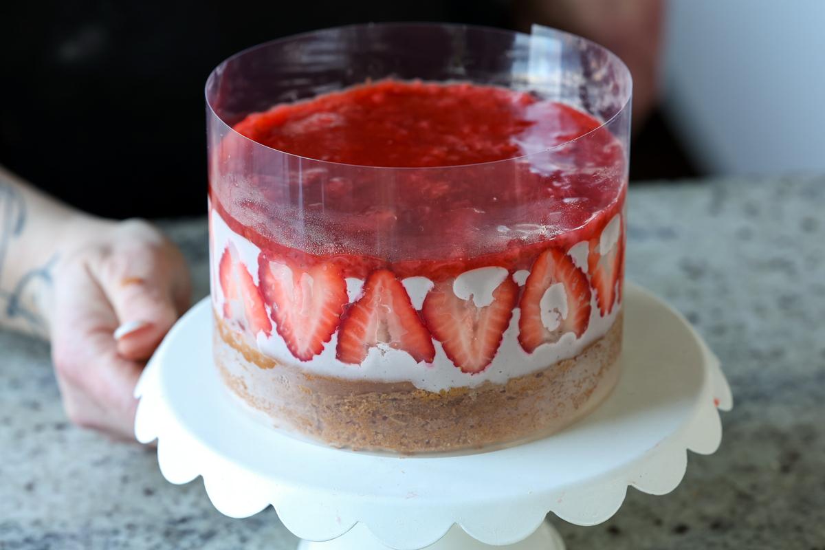 strawberry mousse cake fully assembled inside of the cake collar