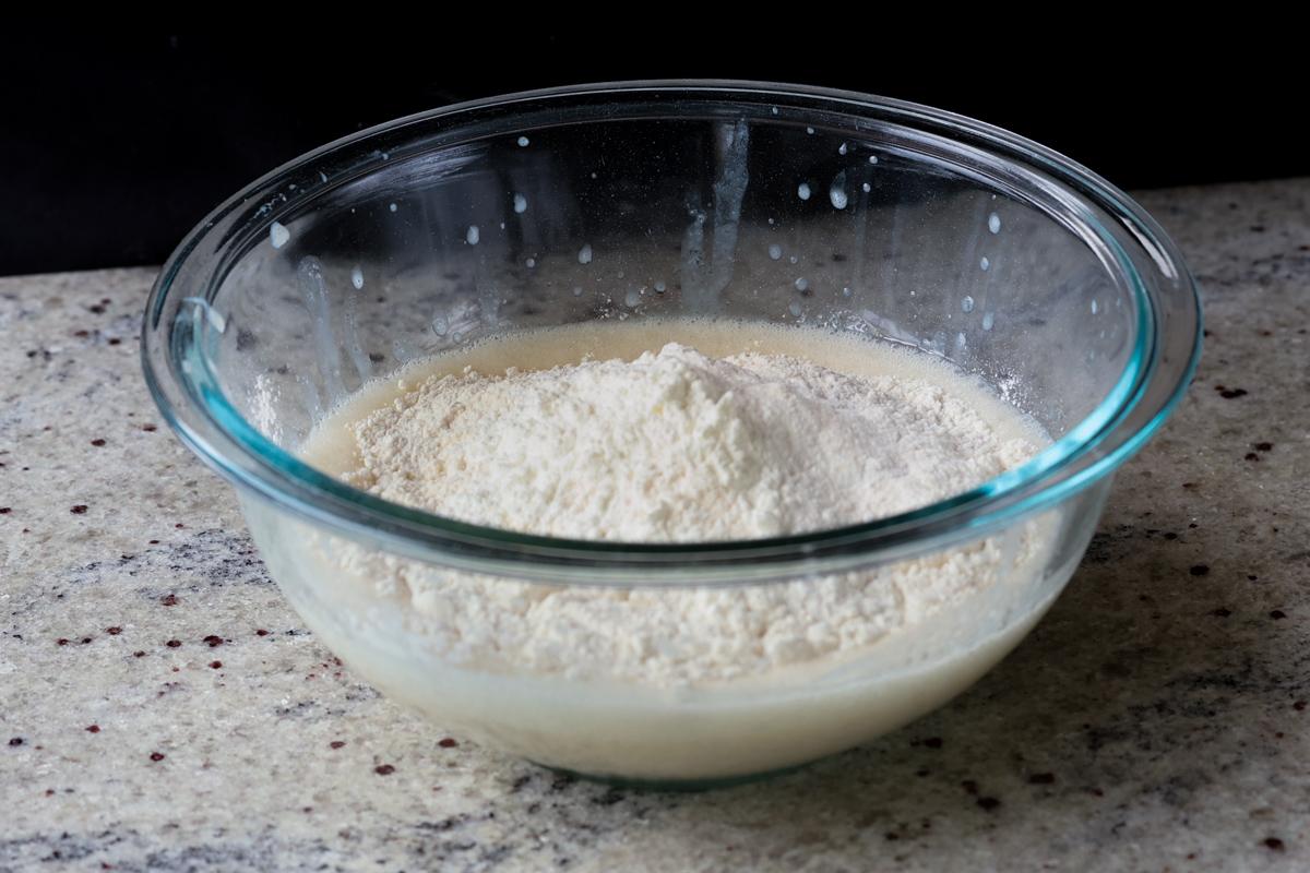 adding dry ingredients to the wet ingredients in a bowl