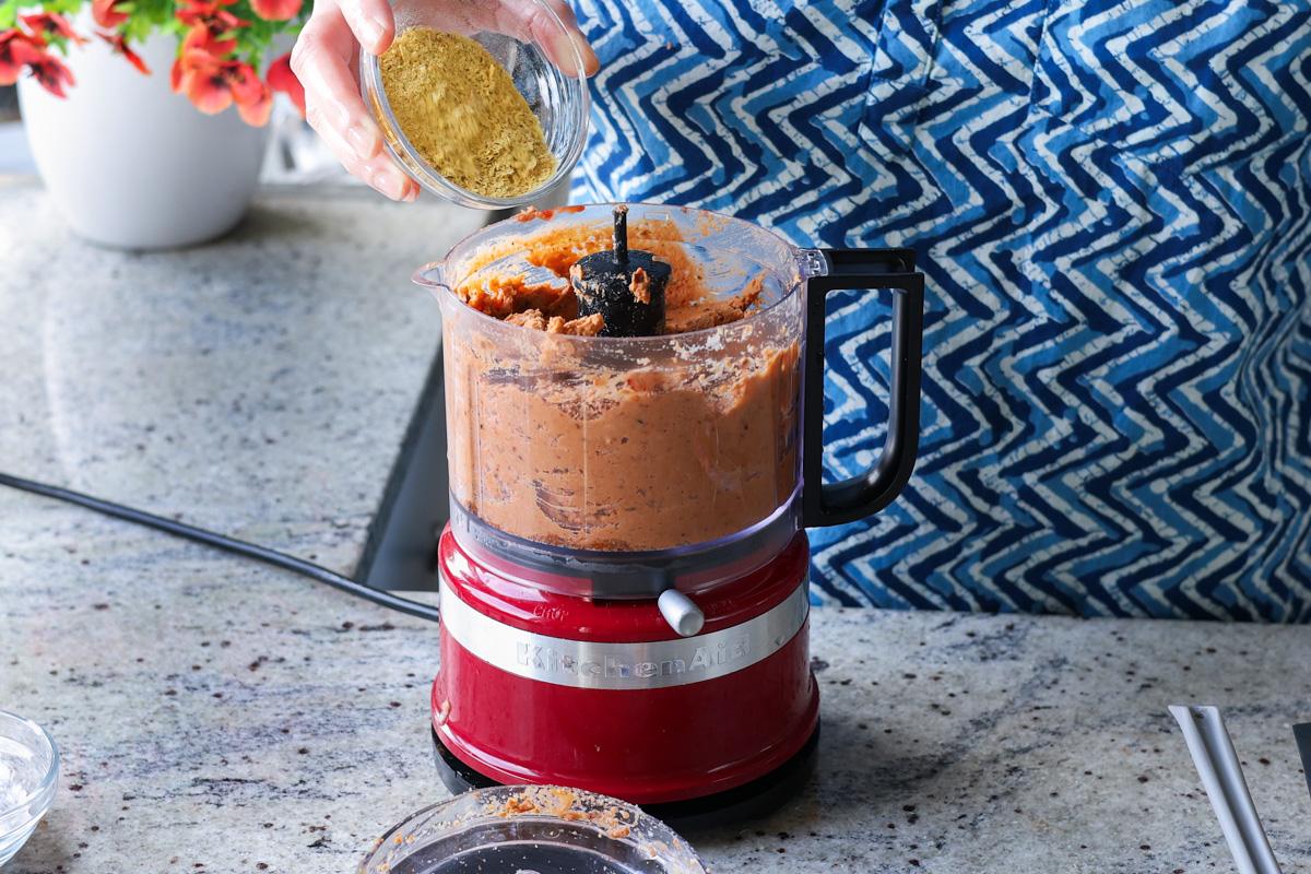 adding nutritional yeast to the food processor