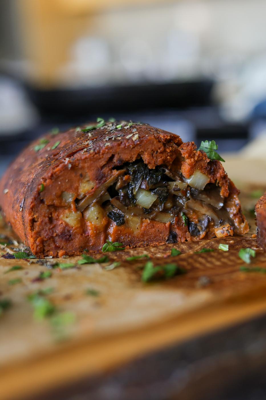 sliced sun dried tomato roast on a cutting board