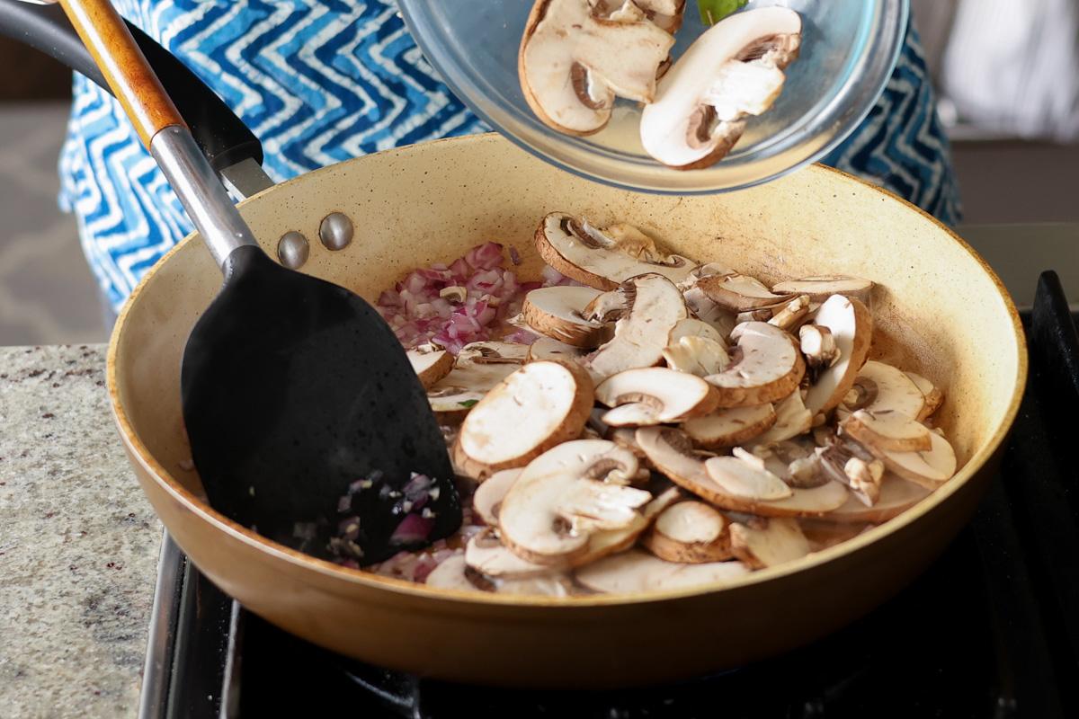 adding mushrooms to the pan