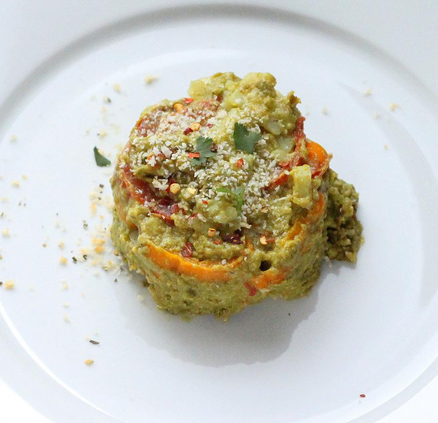 overhead shot of side view of an individual serving of vegan sweet potato Alfredo bake with spinach cashew alfredo sauce