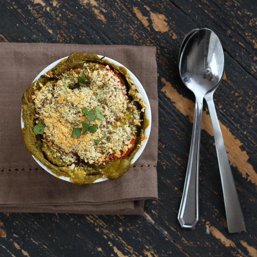 overhead shot of a single serving of vegan spinach Alfredo bake with two spoons on the side