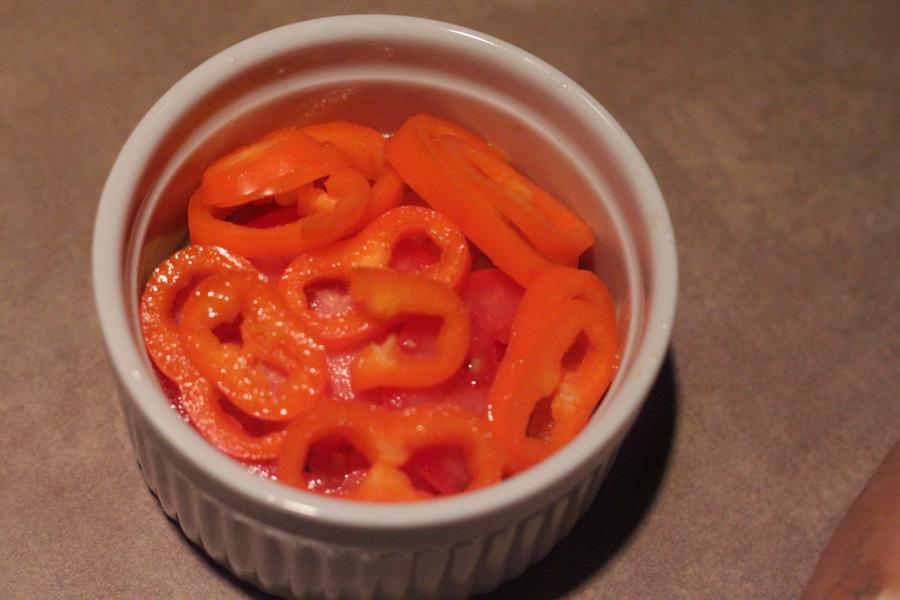 sliced mini bell pepper in a small white casserole dish