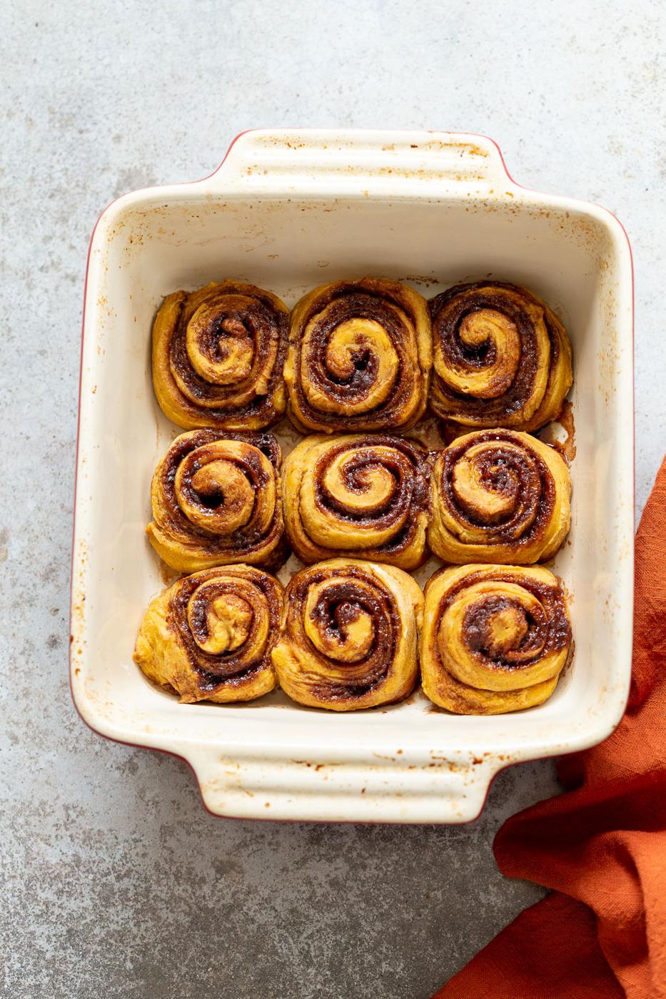 overhead shot of a casserole dish with freshly baked cinnamon rolls