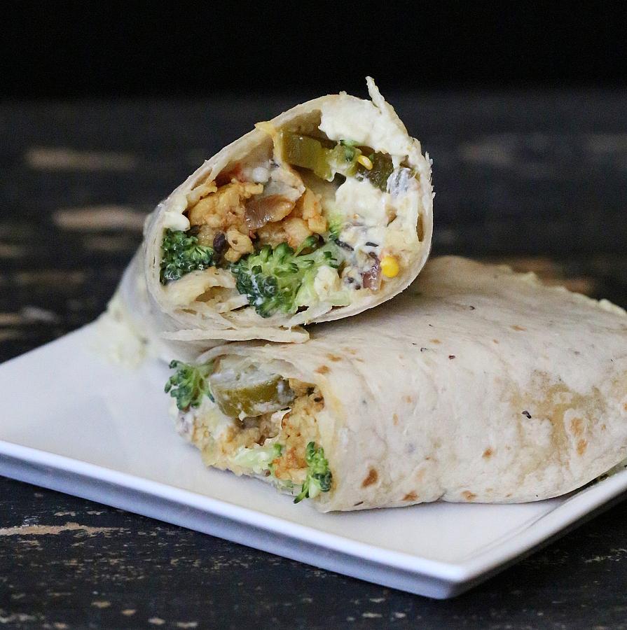 vegan tempeh scramble wraps with cashew cream and broccoli on a square white plate