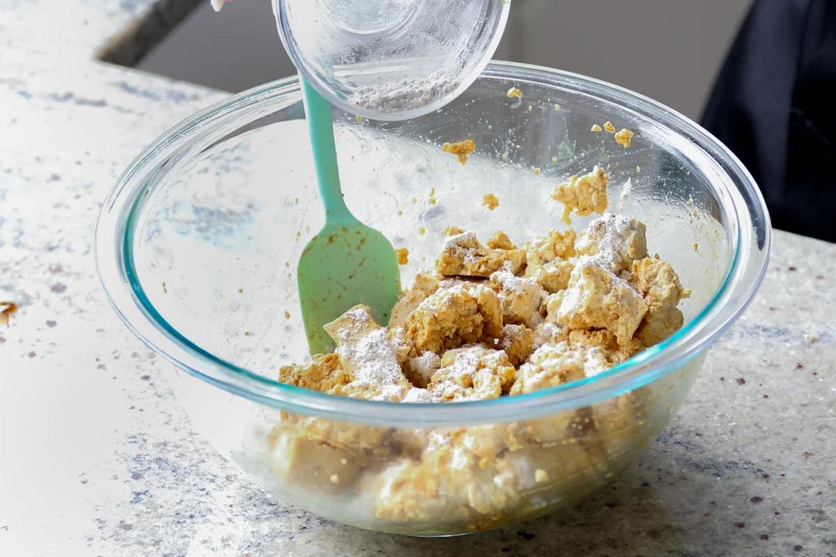 adding cornstarch and spices to the tofu