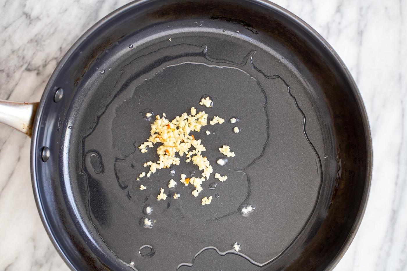 minced garlic sauteeing in oil in a saucepan